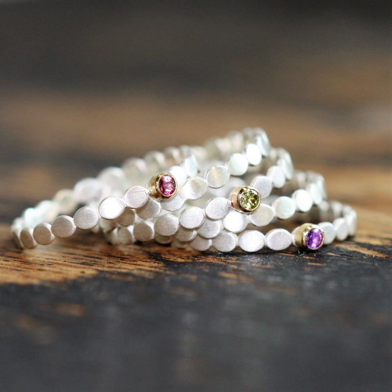 Five silver and 18ct gold pebble ring stack