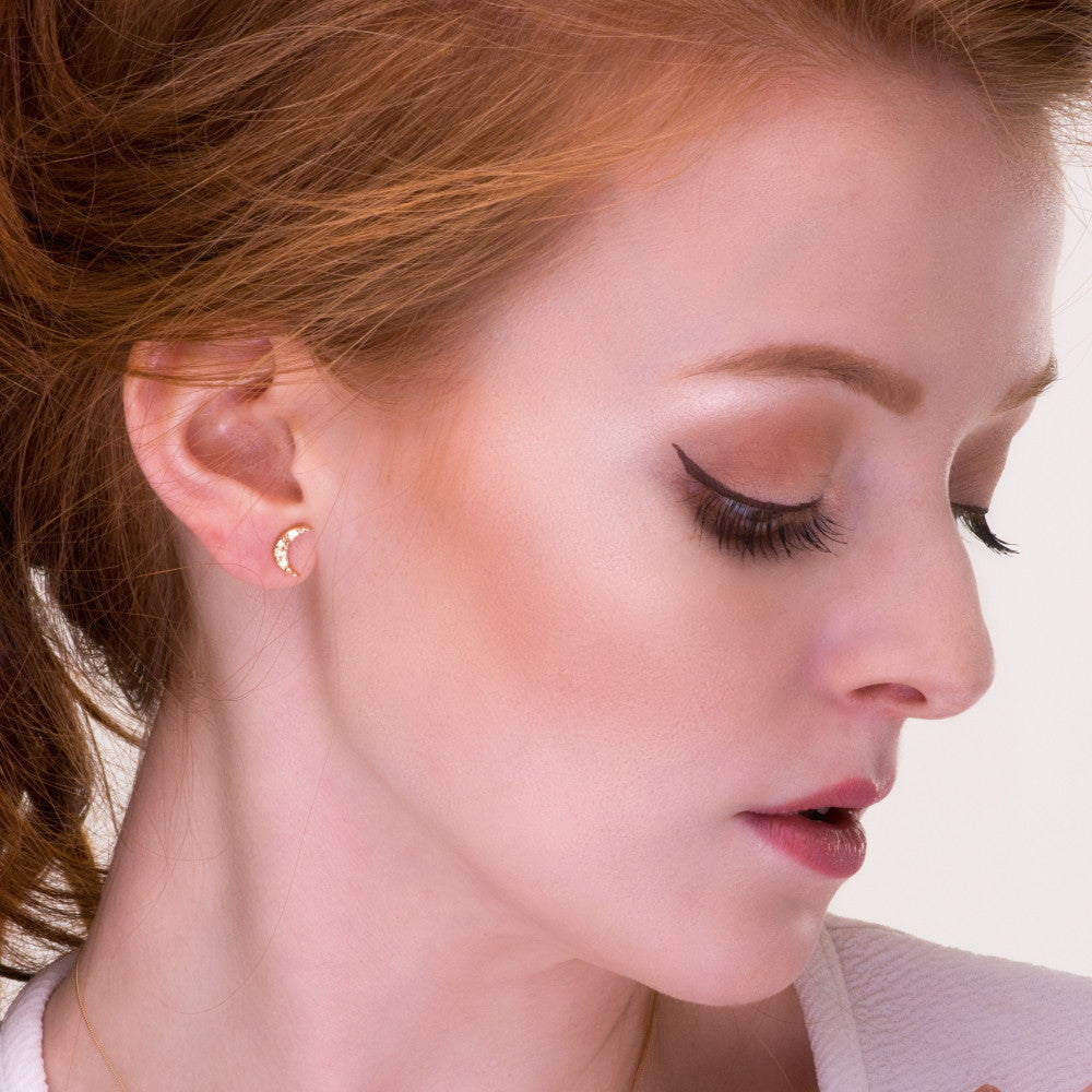 Model wearing the Universe new moon stud earrings in 9ct gold
