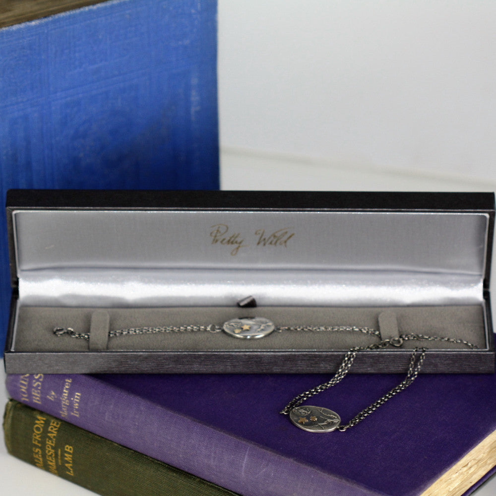 unusual fairy holding onto her dandelion with magical gold stars