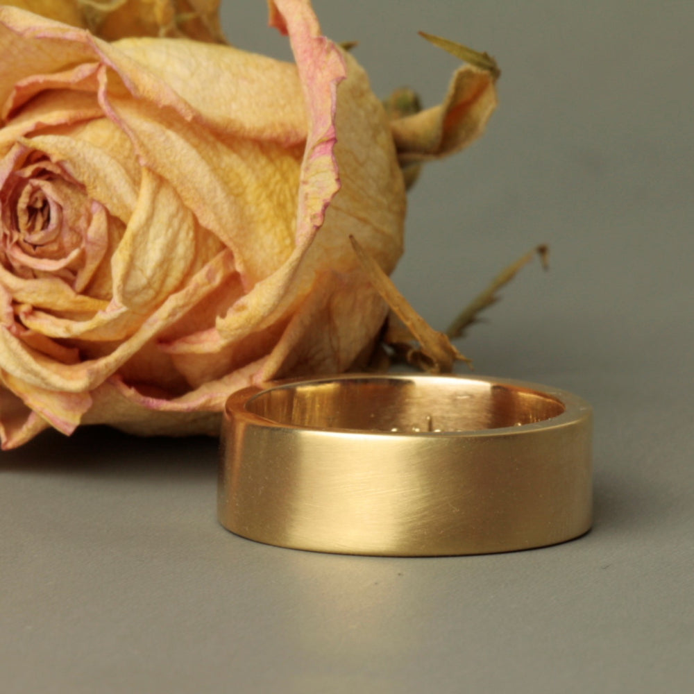 thick gold heavy wedding band with a matt brushed finish