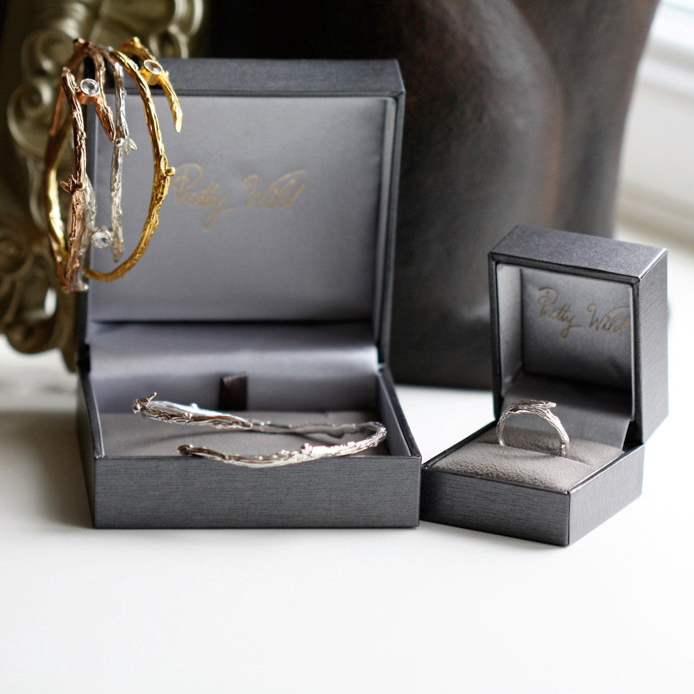 gold twig branch bangle with white topaz dew drop